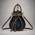 The Elowen Denim-Leather Mini Bucket Bag — Dark Indigo — front